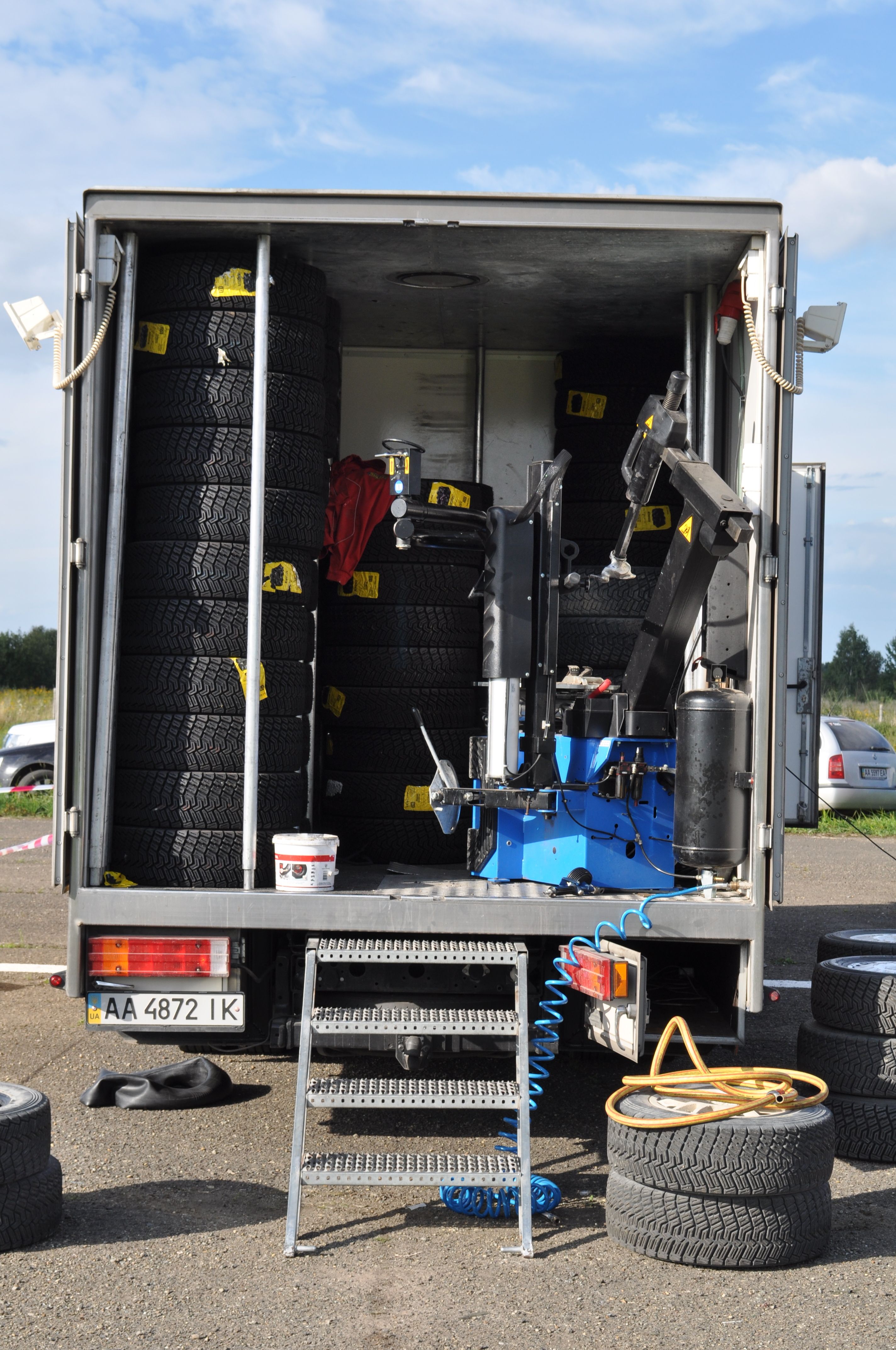 Mobile tire repair truck stocked with tires and equipment for roadside assistance