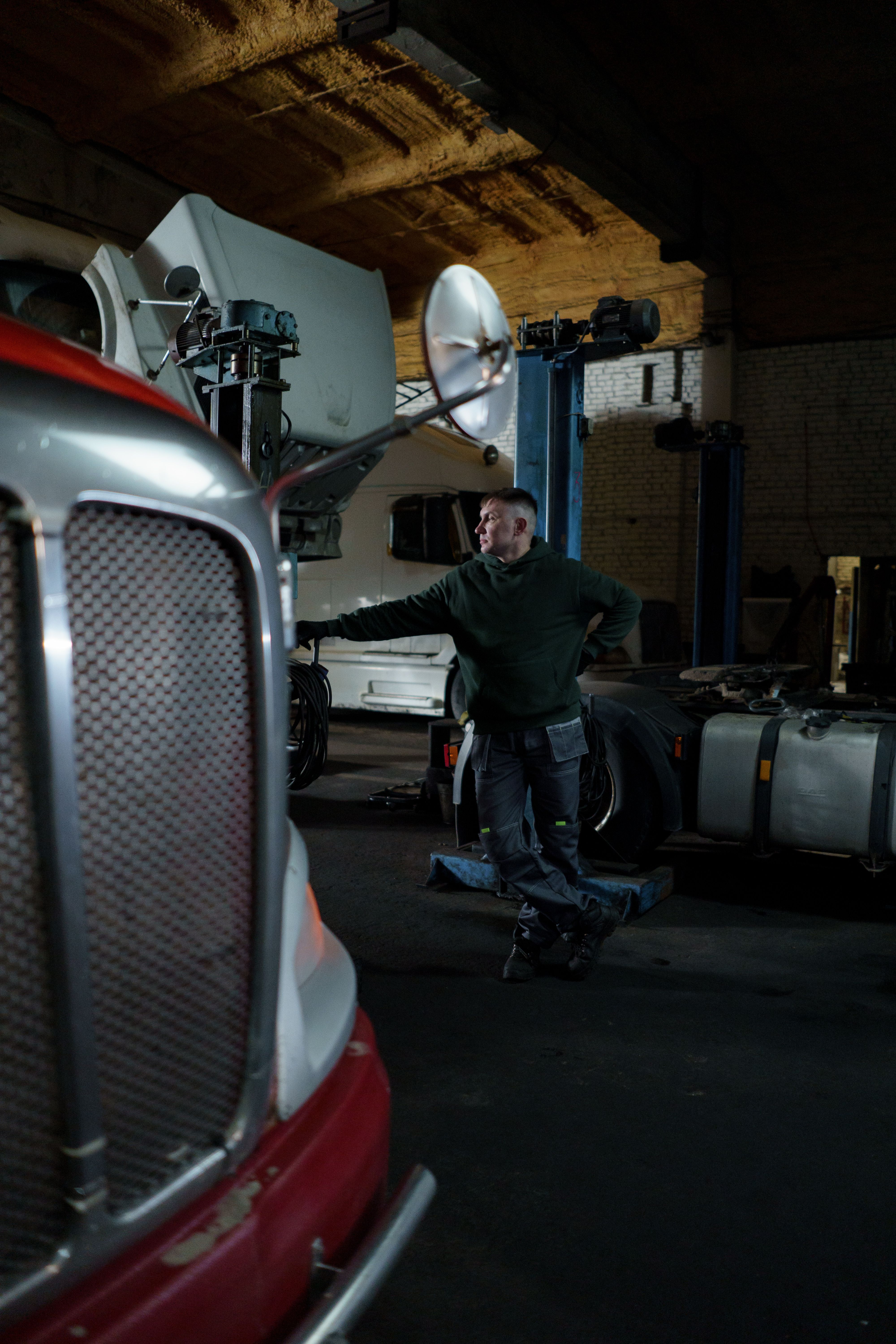 Mechanic working on a semi-truck engine, illustrating professional truck repair service